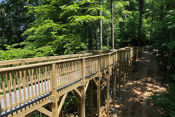 A large wooden ramp leading to the zipline launch.
