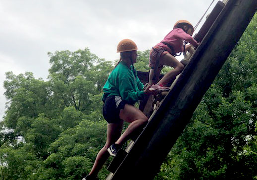 People climbing log ladder